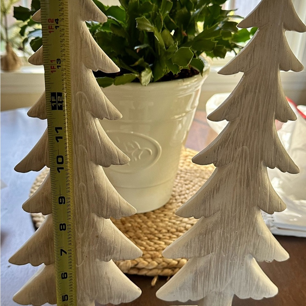 Two 16 inch tall off white Christmas trees  inside they are wood or plaster